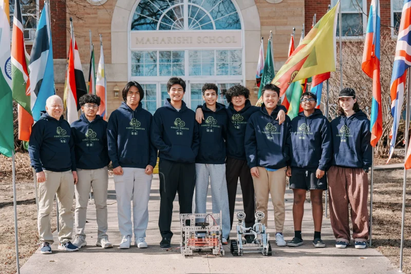 The Maharishi School robotics team with their robots