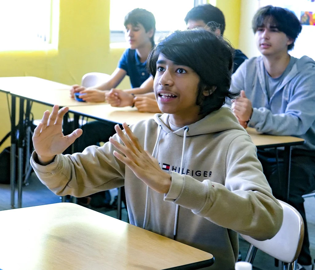 A high school student asking a question in class