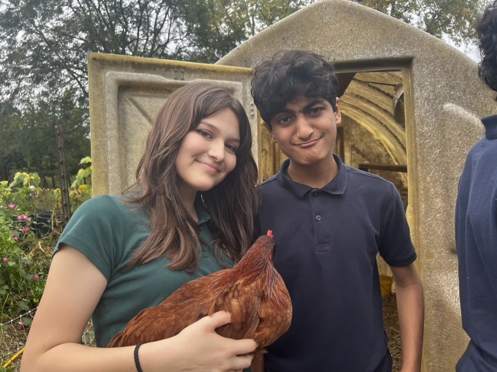 Middle school students with a chicken from the school garden