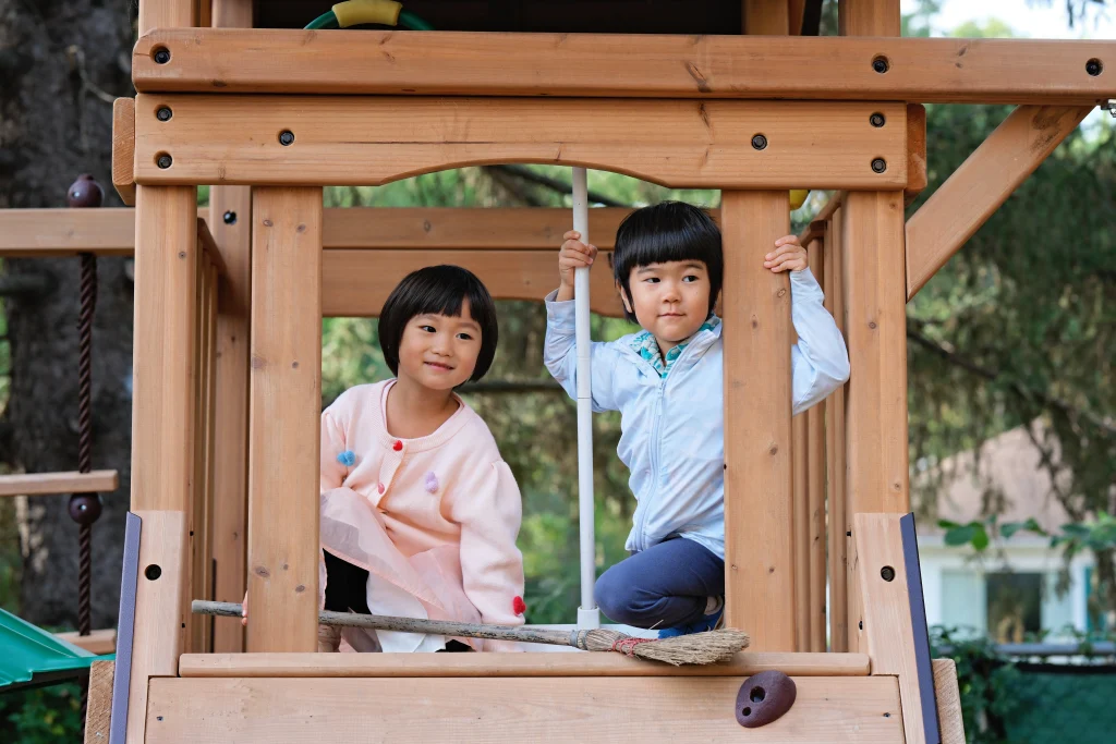 Preschool children playing on the outdoor play structure