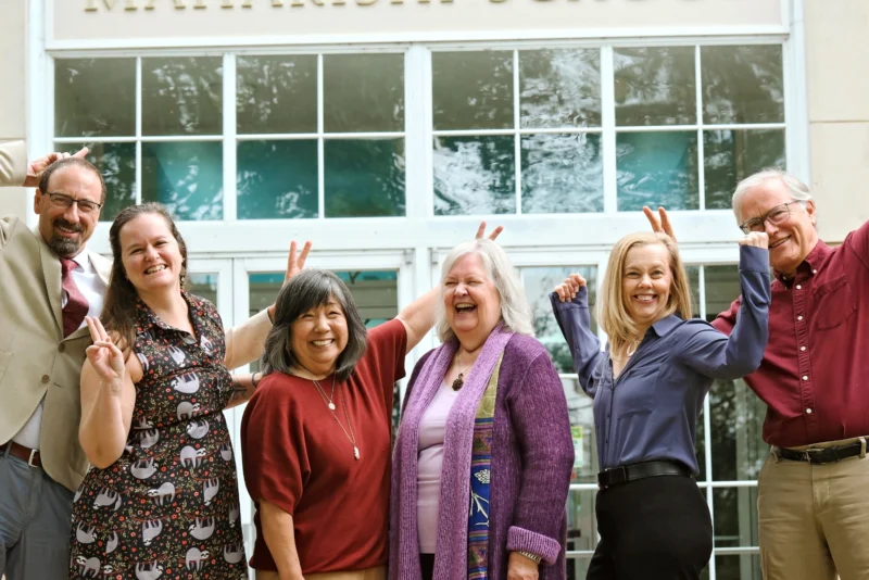 Leadership team at maharishi school posing joyfully and playfully