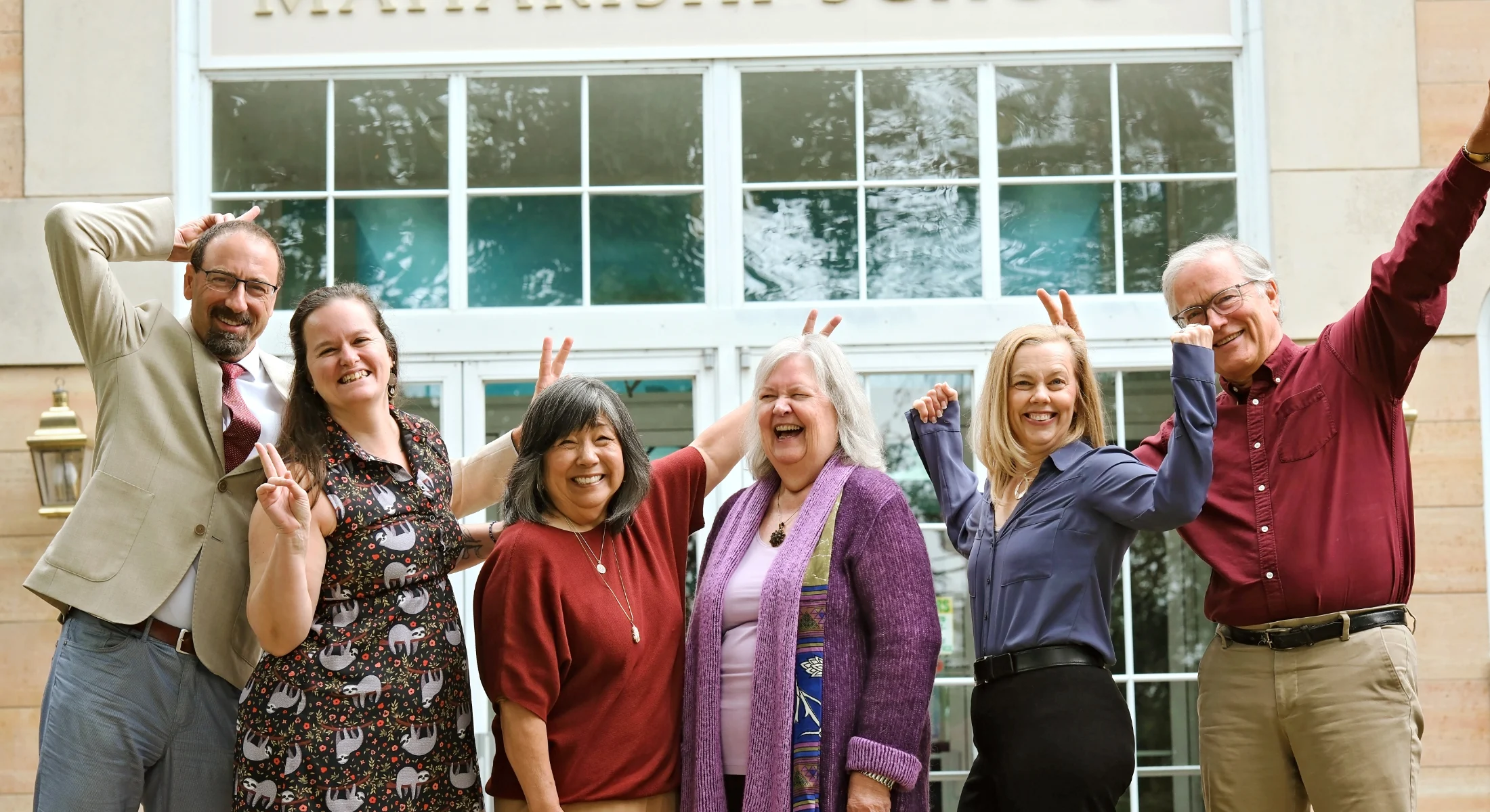 Leadership team at maharishi school posing joyfully and playfully