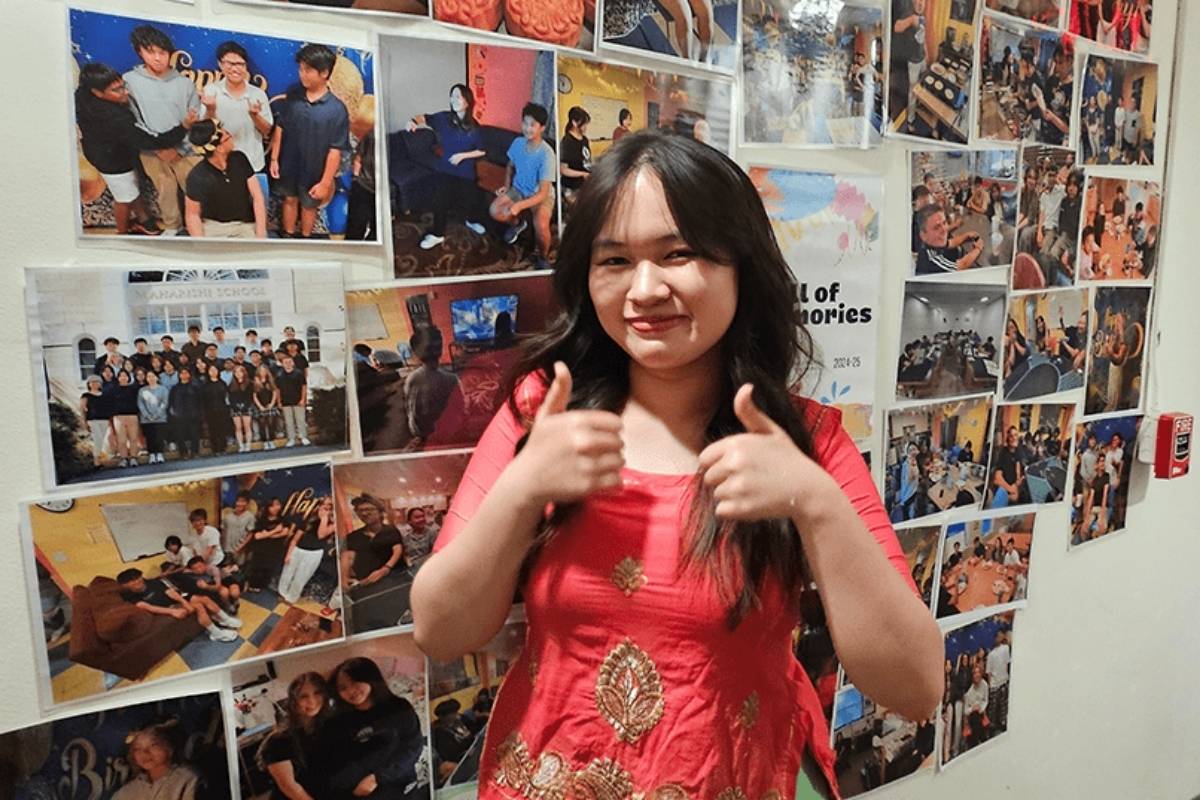 boarding student with international picture wall